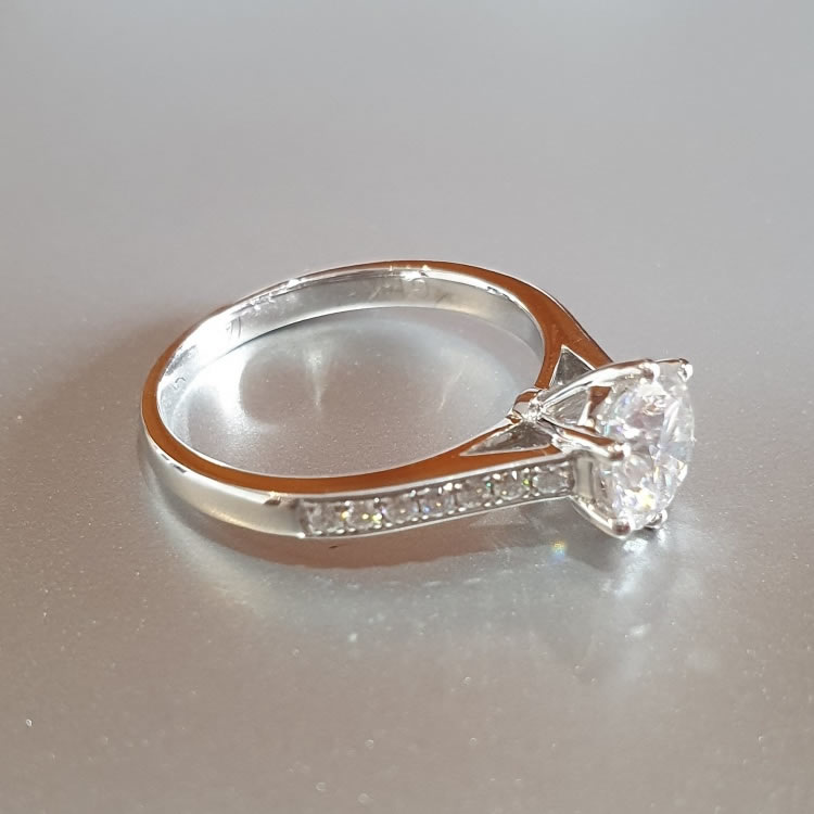 1.2ct Moissanite Engagement ring set in 14k white gold, with shoulder gemstones.